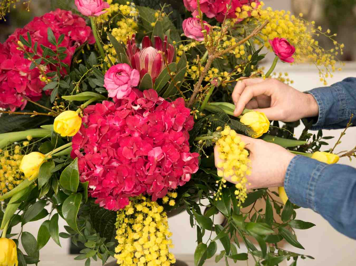 Florist arranging a colorful flower bouquet. Florist arranging a colorful flower bouquet using the 3 5 8 rule to create balance, texture, and elegant floral design.