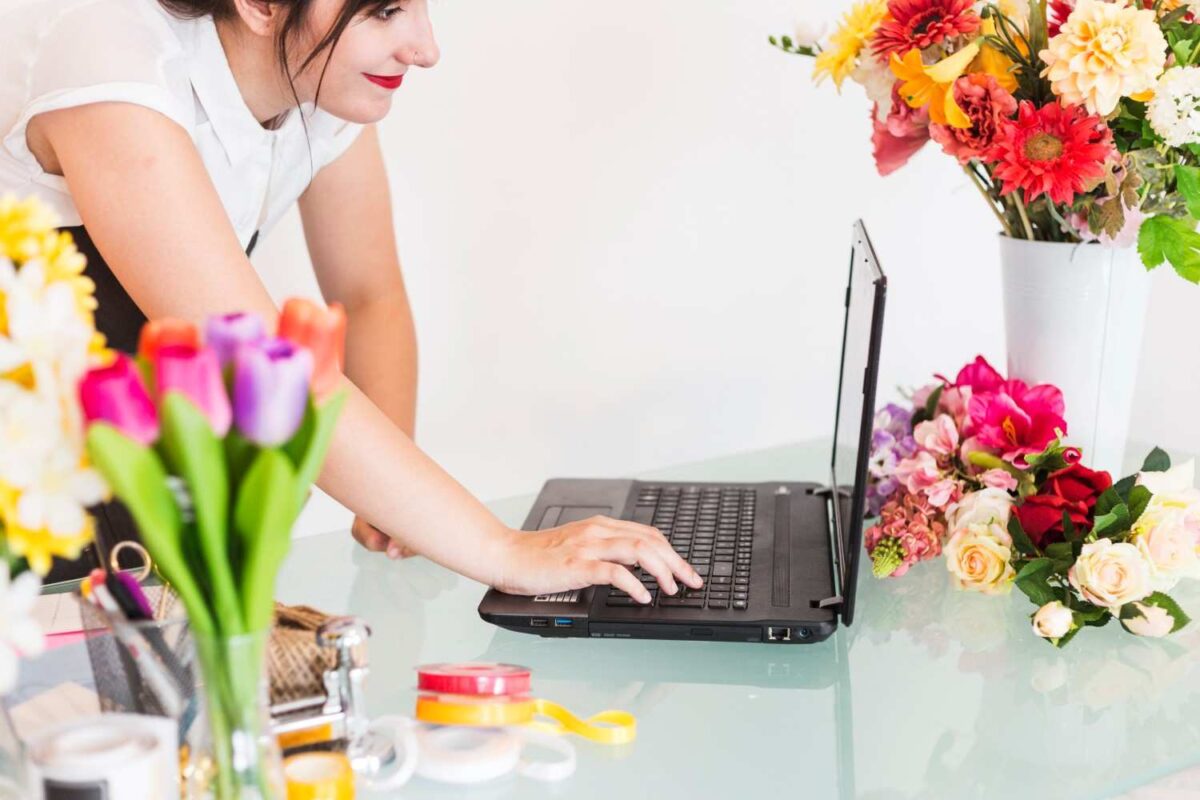 Calgary Florist | How to Choose the Best Fresh Flowers Online Without Overpaying? A female florist checking fresh flower orders online using laptop.