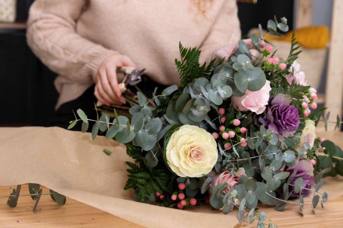 A close up of an affordable premium flower arrangement with white, pink, and purple flowers and green fillers.