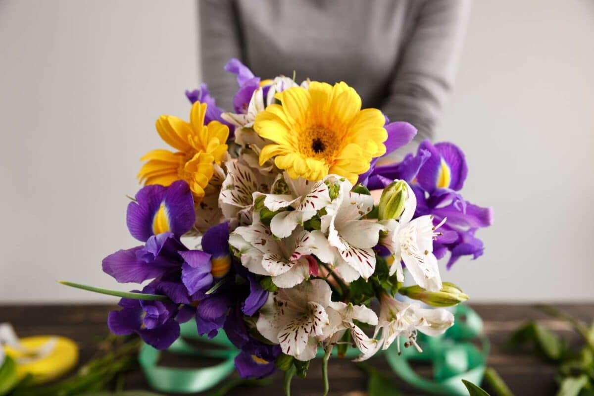 Calgary Florist | When Is the Best Time to Send Flowers? Thoughtful Ideas for Every Moment A woman with a pretty colorful flower bouquet.