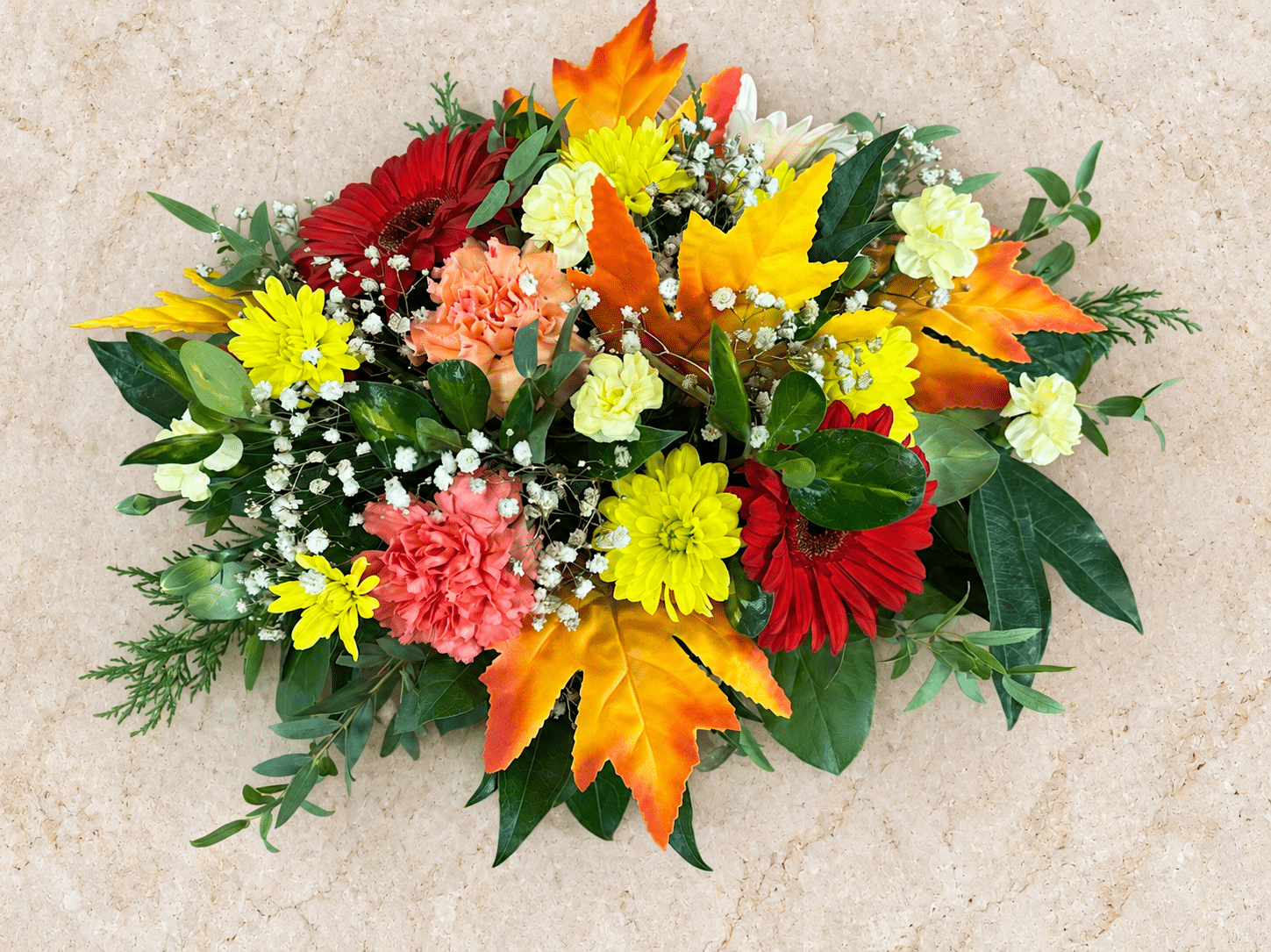 Overhead Oval Floral Arrangement on Warm Stone 1.png