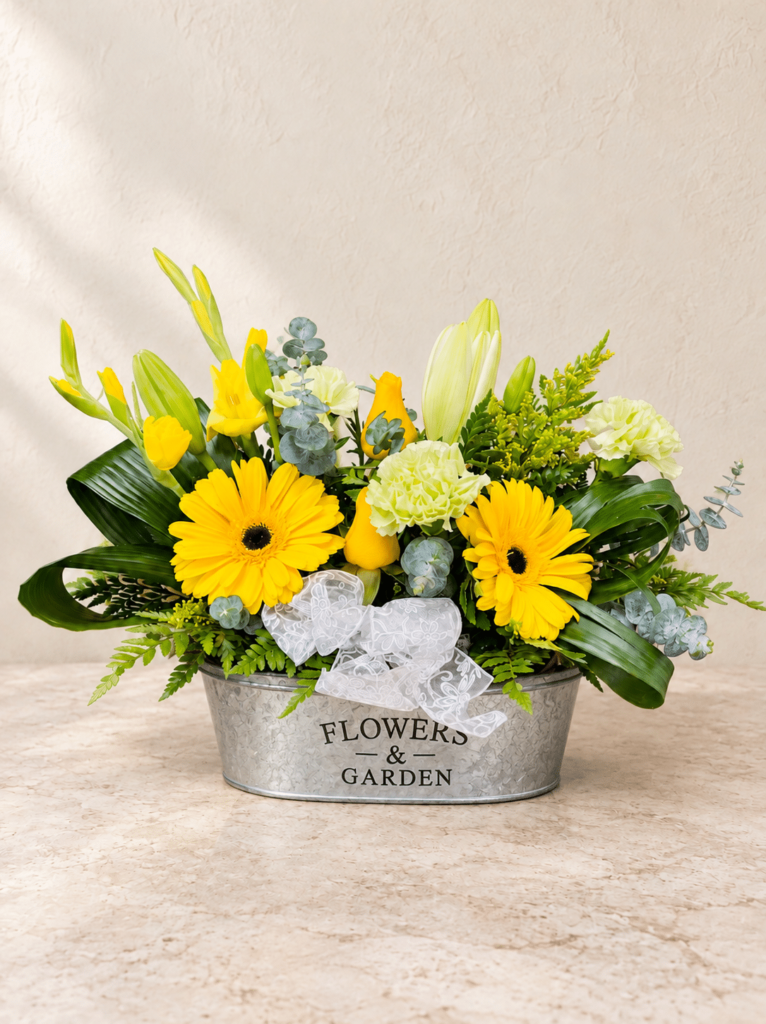 Yellow blooms in a silver garden planter 1.png